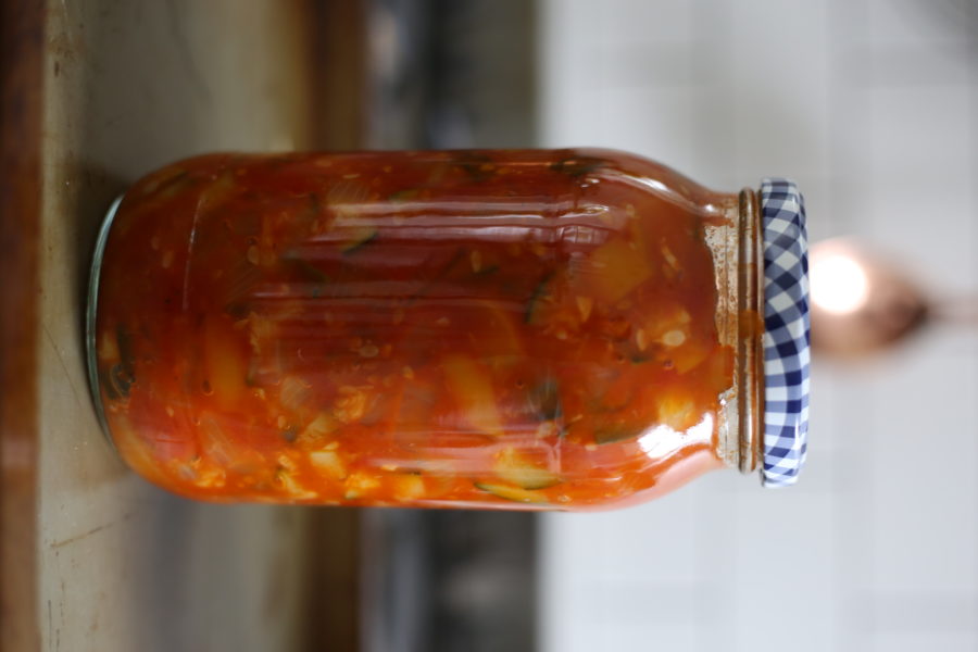 A jar of preserved tomatoes and vegetables