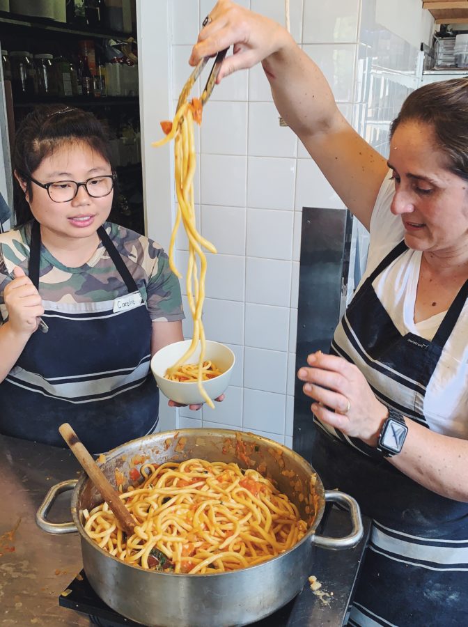 Lifting fresh pasta from the pot during a class