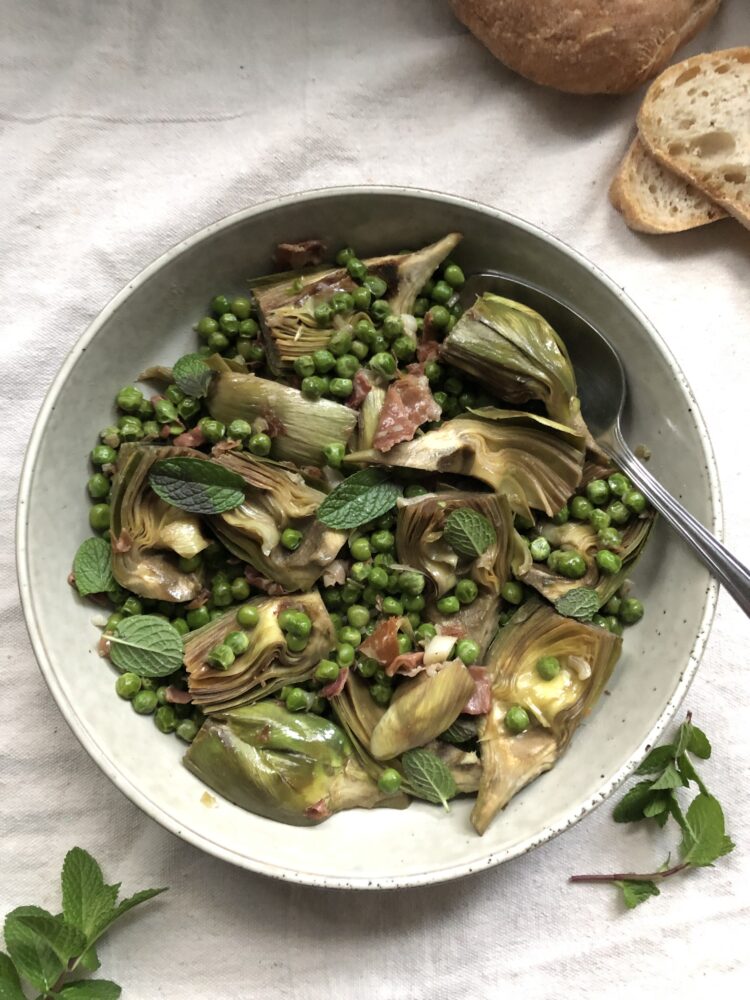 Braised artichokes with peas, prosciutto and mint, bread alongside