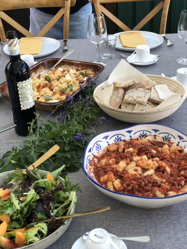 A long lunch laid out — gnocchi in ragu, salad and bread