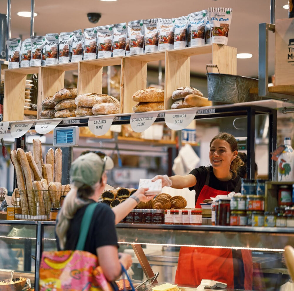 At the bakery counter in the market hall — sourdough, ciabatta and baguettes